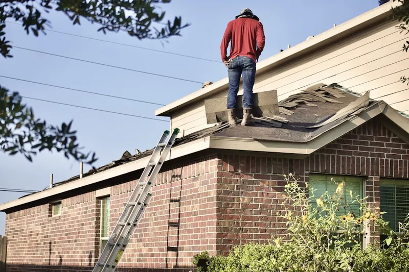 Professional roofer working on a residential roof in Legacy Park